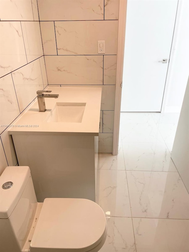 bathroom with vanity, toilet, and tile patterned floors