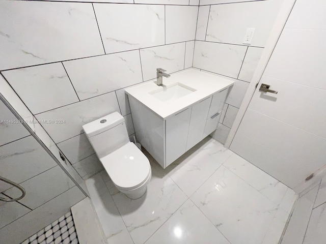 bathroom featuring tile walls, toilet, and sink