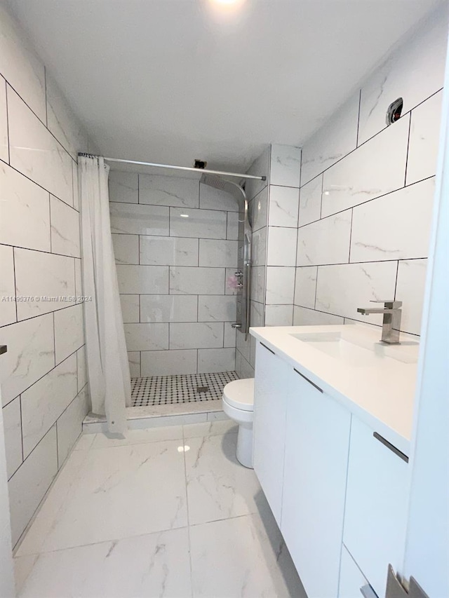 bathroom featuring tile walls, tile patterned flooring, toilet, vanity, and a shower with curtain