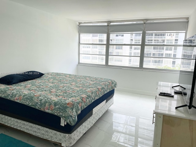 bedroom featuring light tile patterned flooring and multiple windows