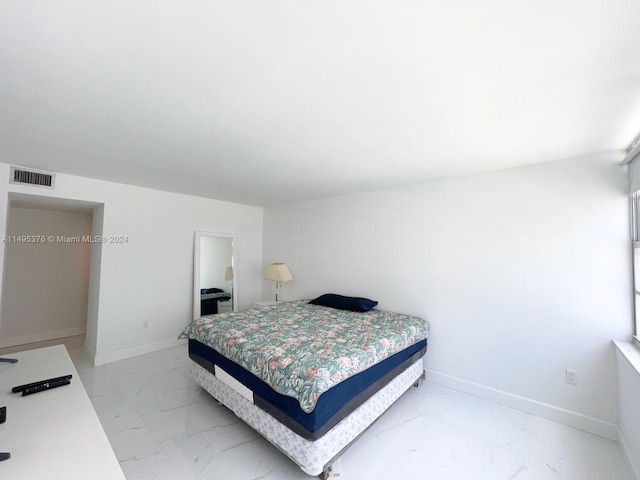 bedroom with light tile patterned floors