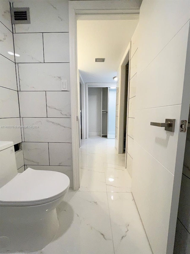 bathroom featuring tile patterned flooring and toilet