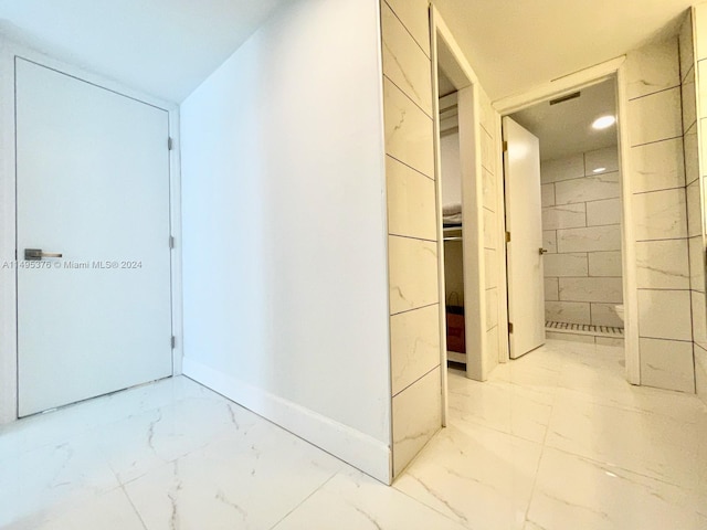 hall featuring light tile patterned flooring