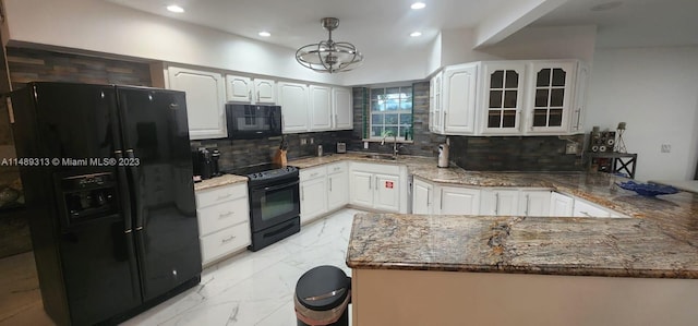 kitchen featuring black appliances, white cabinets, backsplash, dark stone countertops, and an inviting chandelier