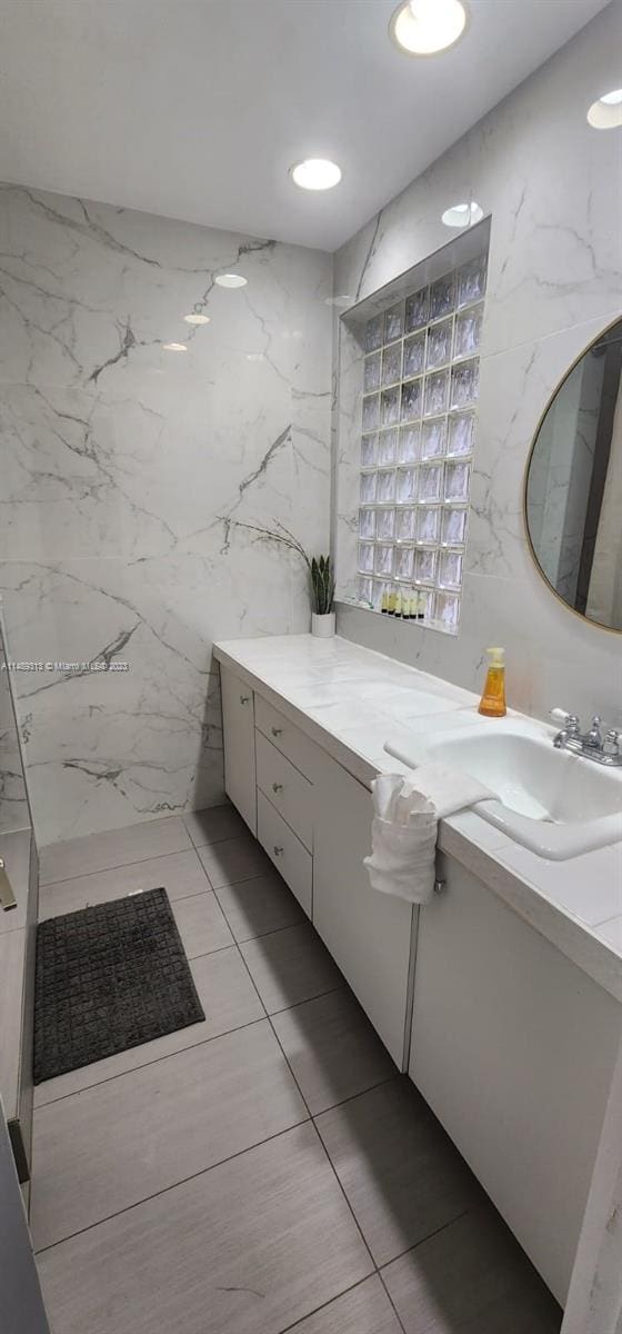 bathroom featuring tile walls, tile floors, and vanity