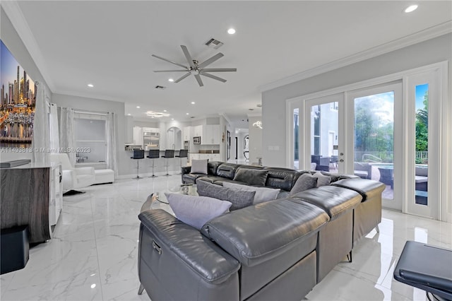 living room with french doors, ceiling fan, and crown molding