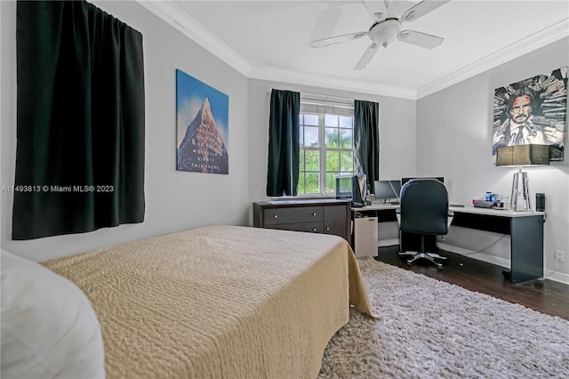 bedroom featuring dark hardwood / wood-style flooring, ceiling fan, and crown molding