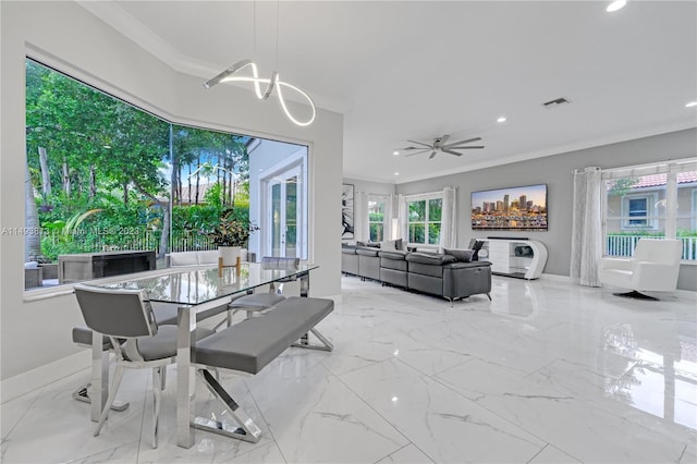 dining area with ceiling fan and ornamental molding