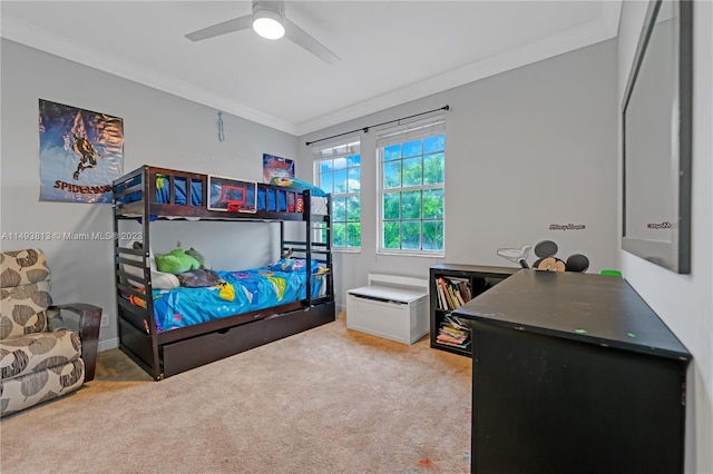 carpeted bedroom with ceiling fan and crown molding