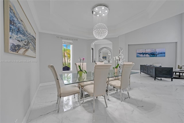 dining room featuring a tray ceiling, ornamental molding, and a notable chandelier