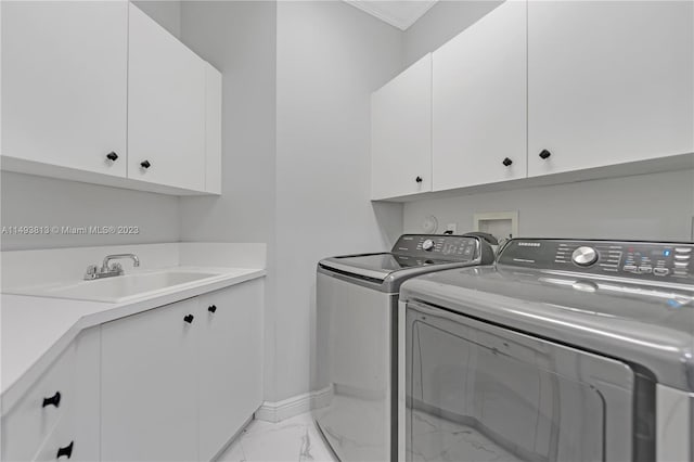 laundry room with ornamental molding, sink, cabinets, and independent washer and dryer