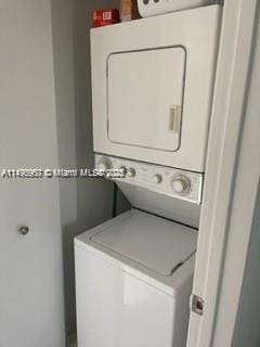 laundry room with stacked washer and dryer