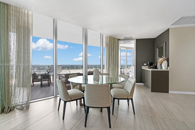 dining area featuring floor to ceiling windows