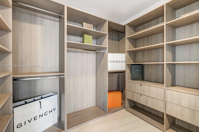 walk in closet featuring light hardwood / wood-style flooring