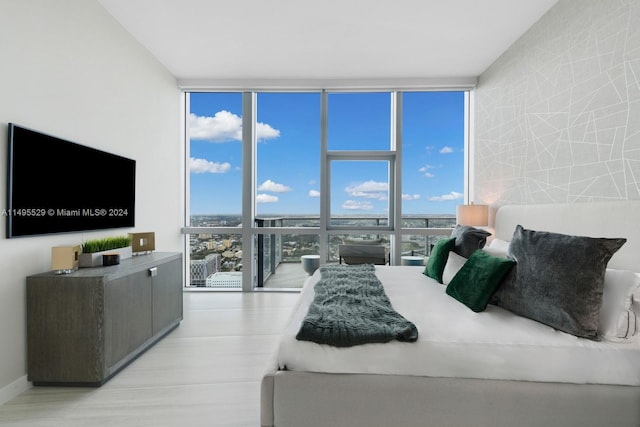 interior space with light hardwood / wood-style flooring and a wall of windows