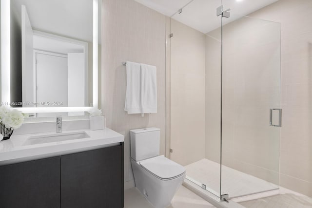 bathroom featuring a shower with door, oversized vanity, toilet, and tile flooring