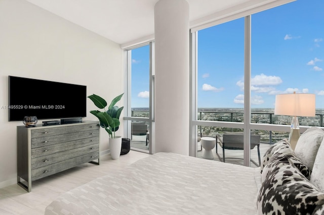 bedroom with floor to ceiling windows and multiple windows