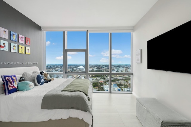 tiled bedroom featuring a wall of windows