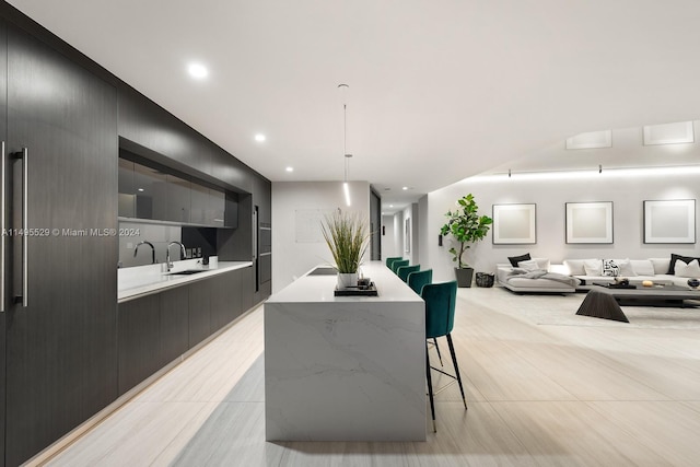 dining area featuring sink and light tile floors