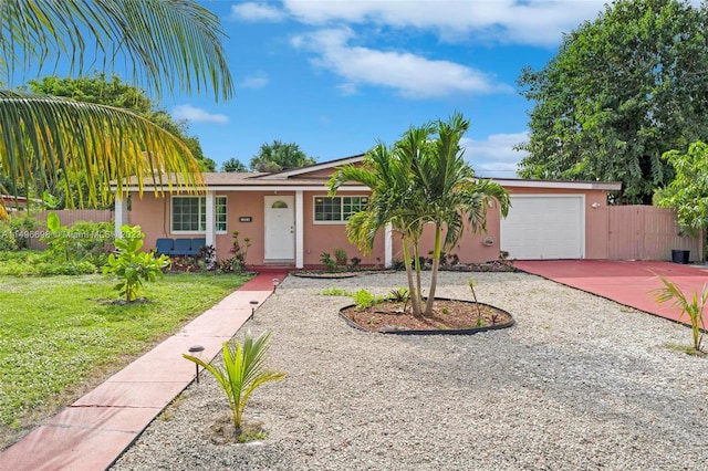 ranch-style house with a garage and a front lawn