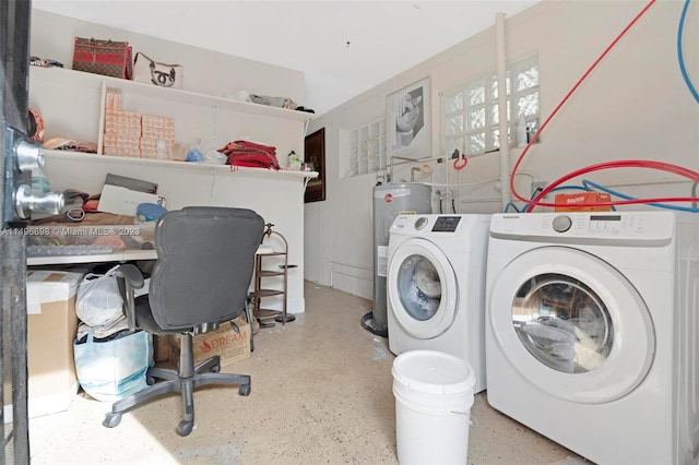 laundry room with electric water heater and separate washer and dryer