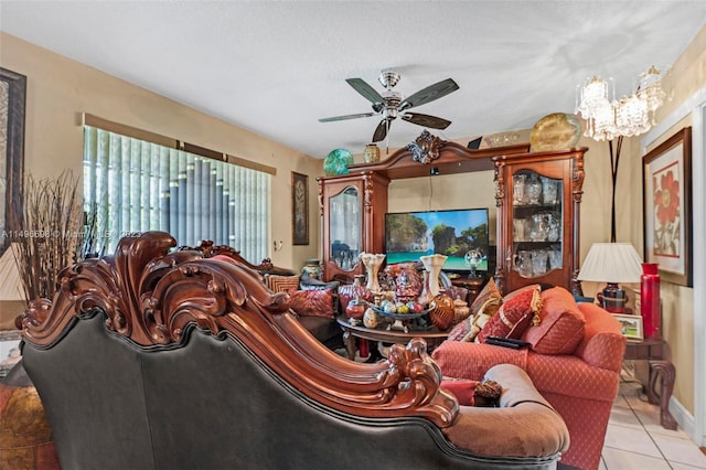 living room featuring ceiling fan with notable chandelier and light tile patterned floors