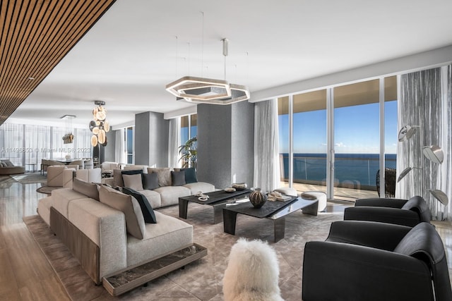 living room featuring a water view, floor to ceiling windows, and wood-type flooring