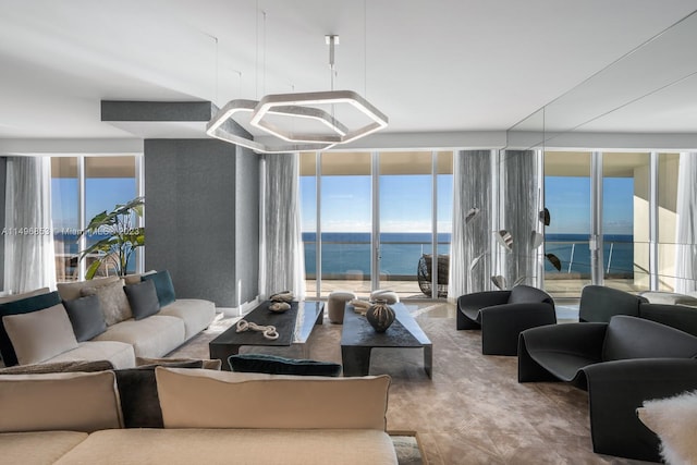 living room featuring a water view and expansive windows