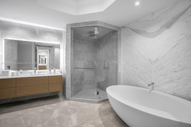 bathroom with vanity, tile walls, independent shower and bath, and tile patterned floors