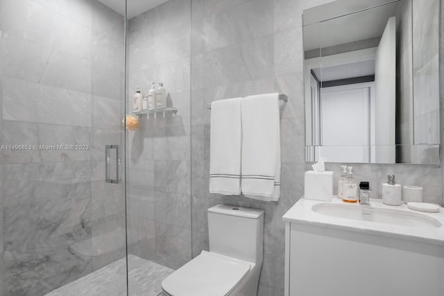 bathroom featuring vanity, an enclosed shower, tile walls, and toilet