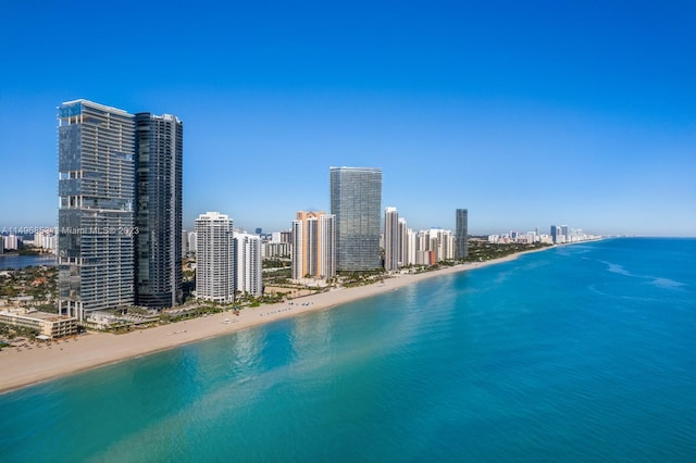 drone / aerial view featuring a water view and a beach view