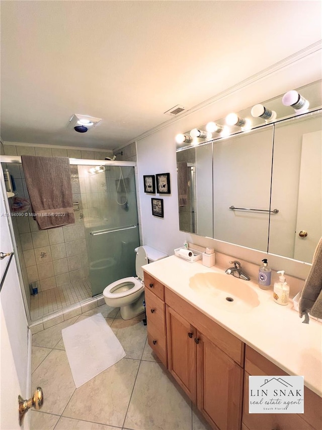 bathroom with tile patterned flooring, vanity, an enclosed shower, and toilet