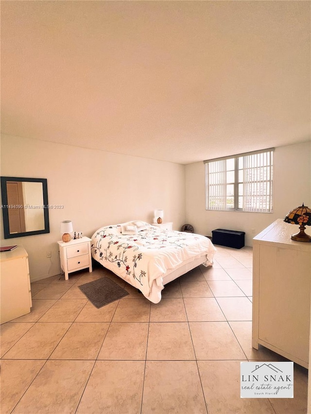 bedroom featuring light tile patterned floors