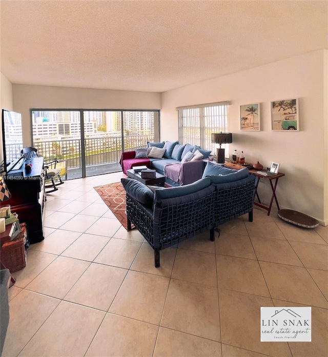 tiled living room featuring a textured ceiling