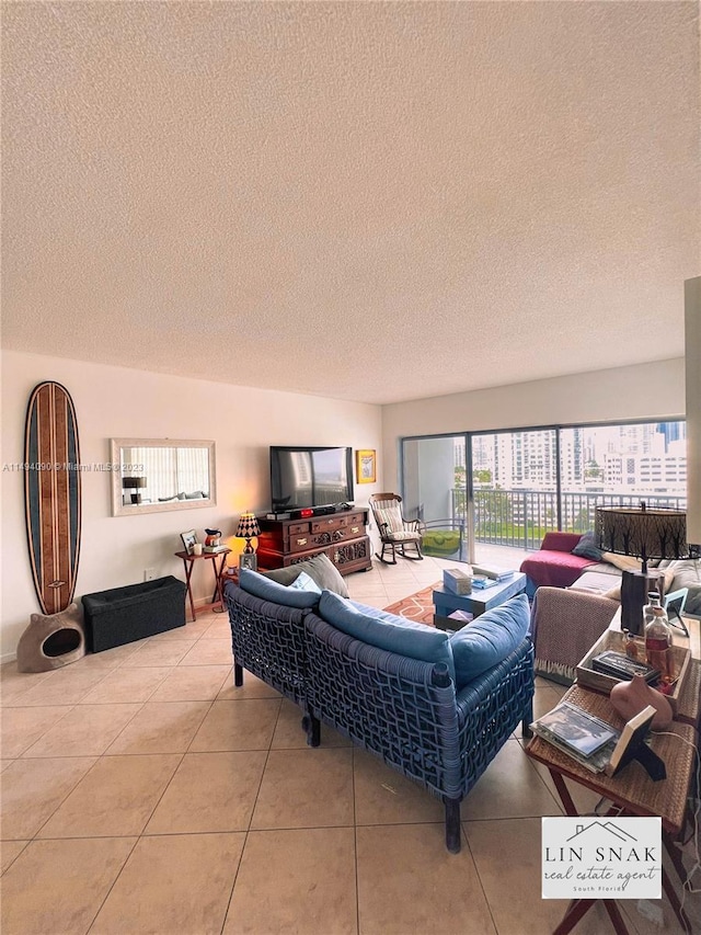 living room with light tile patterned floors and a textured ceiling