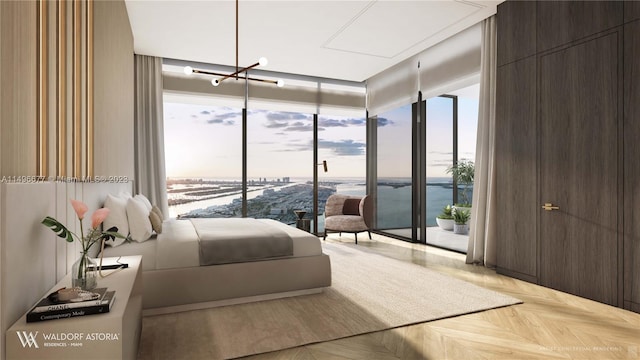 bedroom with light parquet flooring and a water view