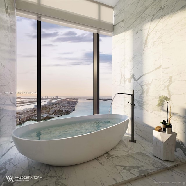 bathroom with tile patterned floors, tile walls, and a water view