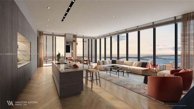 living room featuring expansive windows, a healthy amount of sunlight, light parquet flooring, and a water view