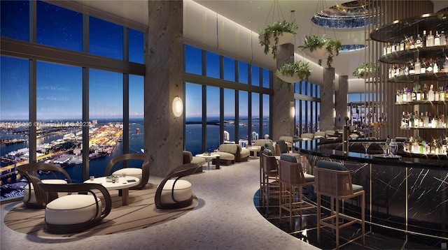 bar with a towering ceiling and a water view