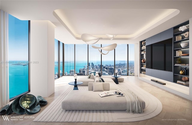 bedroom featuring floor to ceiling windows and a tray ceiling