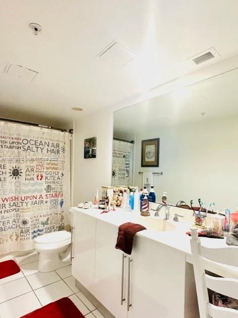 bathroom with vanity, toilet, a shower with shower curtain, and tile patterned floors