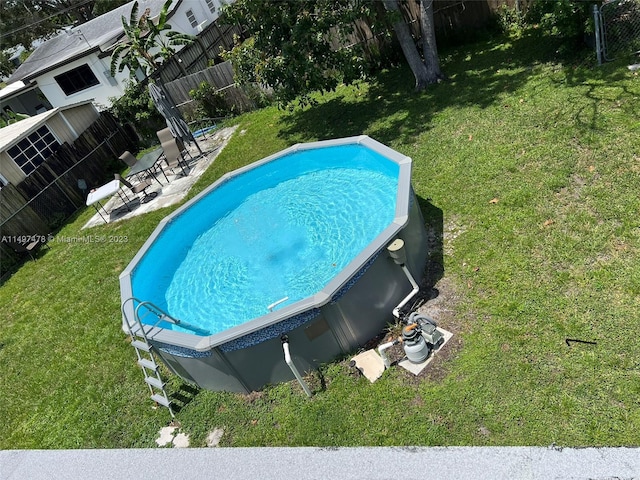 view of swimming pool with a lawn and a patio