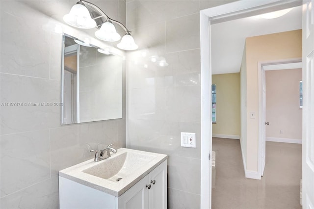 bathroom with tile walls, tile floors, and vanity