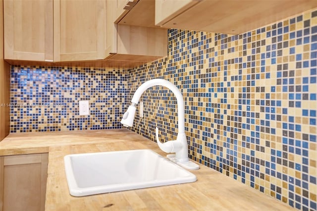 bathroom featuring backsplash and sink