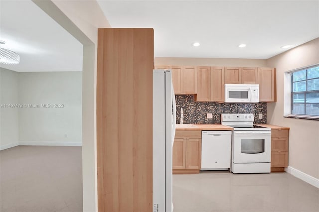 kitchen featuring light tile flooring, light brown cabinetry, white appliances, backsplash, and sink