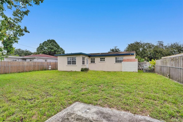 back of property featuring a lawn