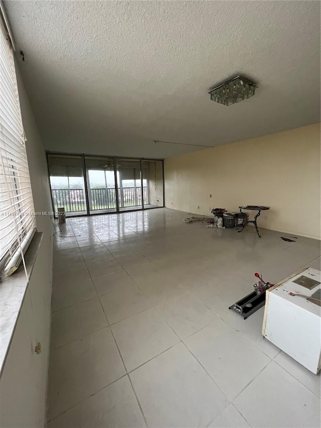 empty room featuring light tile patterned floors and a textured ceiling