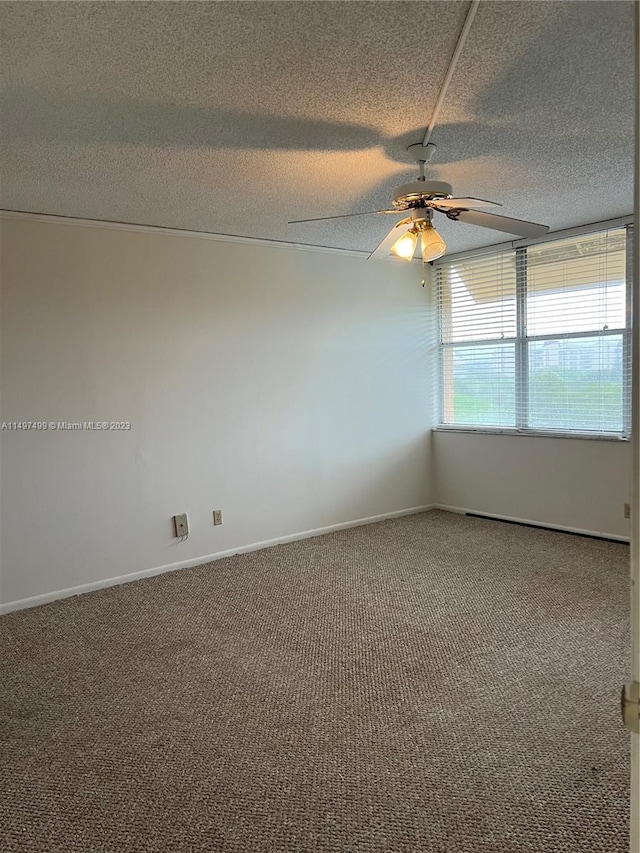 carpeted empty room with a textured ceiling and ceiling fan