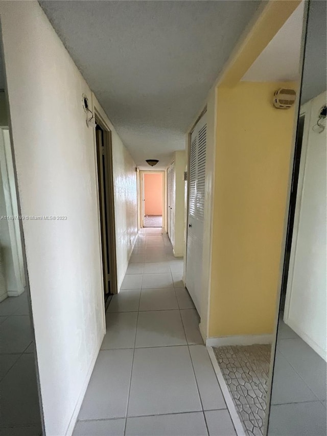 hallway featuring light tile patterned floors