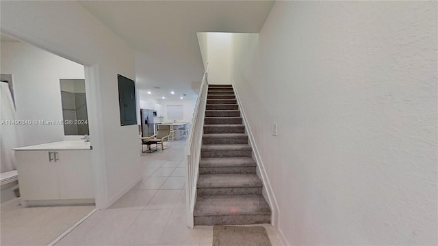 stairway featuring light tile floors